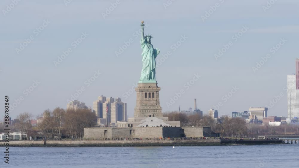 Passing the Statue of Liberty on Liberty Island on the ferry with another ferry entering the frame from the left and seaguls passing the camera. Passing the Statue of Liberty on Liberty Island on the ferry with another ferry entering the frame from the left and seaguls passing the camera.