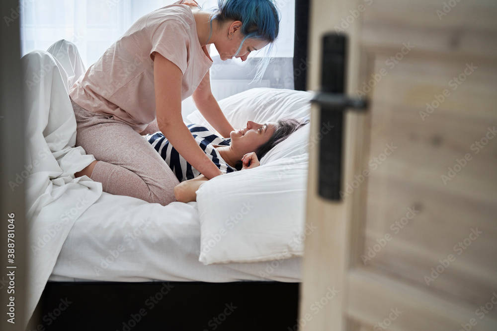 Lesbian couple goofing around in the bedroom Lesbian couple goofing around in the bedroom