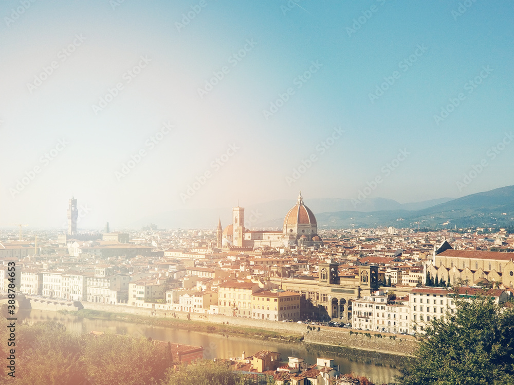 Panorama landscape of Florence and Cathedral Saint Mary of the Flower. Beautiful cityscape of Firenze, Arno river and Duomo Santa Maria del Fiore in sun lights