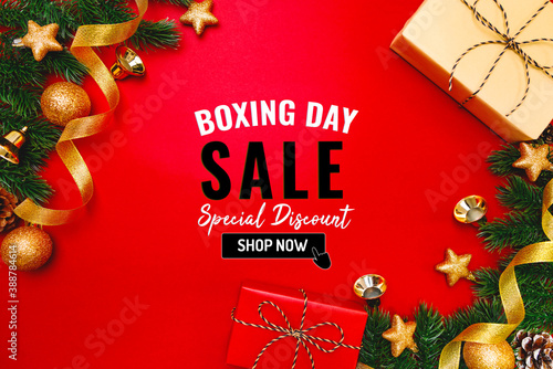 Boxing day sale with Christmas present and xmas decoration on red background photo