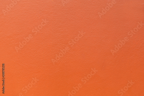 Plastered wall painted orange colour background.
