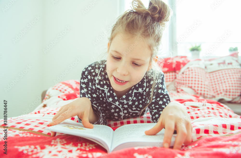Adorable little girl reading book having quarantine because of coronavirus Adorable little girl reading book having quarantine because of coronavirus