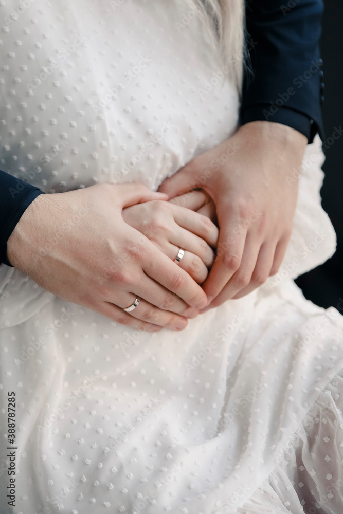 young couple holding hands with a wedding rings young couple holding hands with a wedding rings
