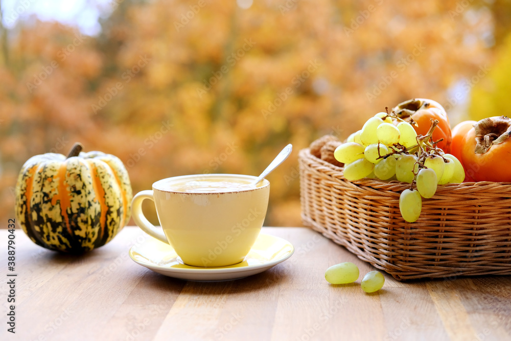 pumpkin, fruits on the table in the garden, beautiful blurred natural landscape, a cup of hot tea, coffee, seasonal concept, cozy autumn mood pumpkin, fruits on the table in the garden, beautiful blurred natural landscape, a cup of hot tea, coffee, seasonal concept, cozy autumn mood
