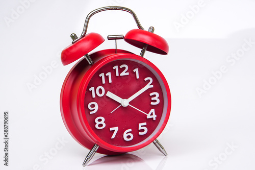 red clock on white background, copy spaсe.