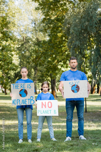 Family of volunteers holding placards with there is no planet b inscription, ecology concept