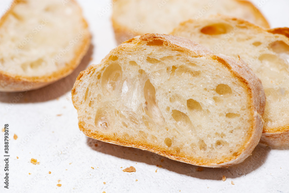 bread cut into slices on white background