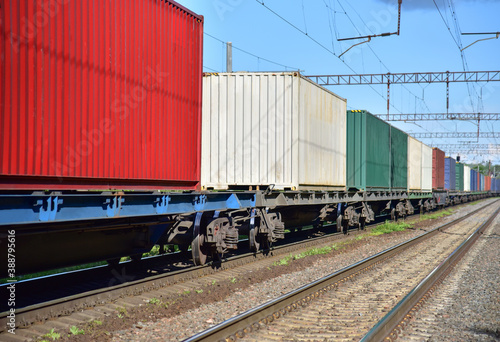 Cargo Containers Transportation On Freight Train By Railway. Intermodal Container On Train Car. Rail Freight Shipping Logistics Concept. Import - export goods from Сhina. Global economy in recession