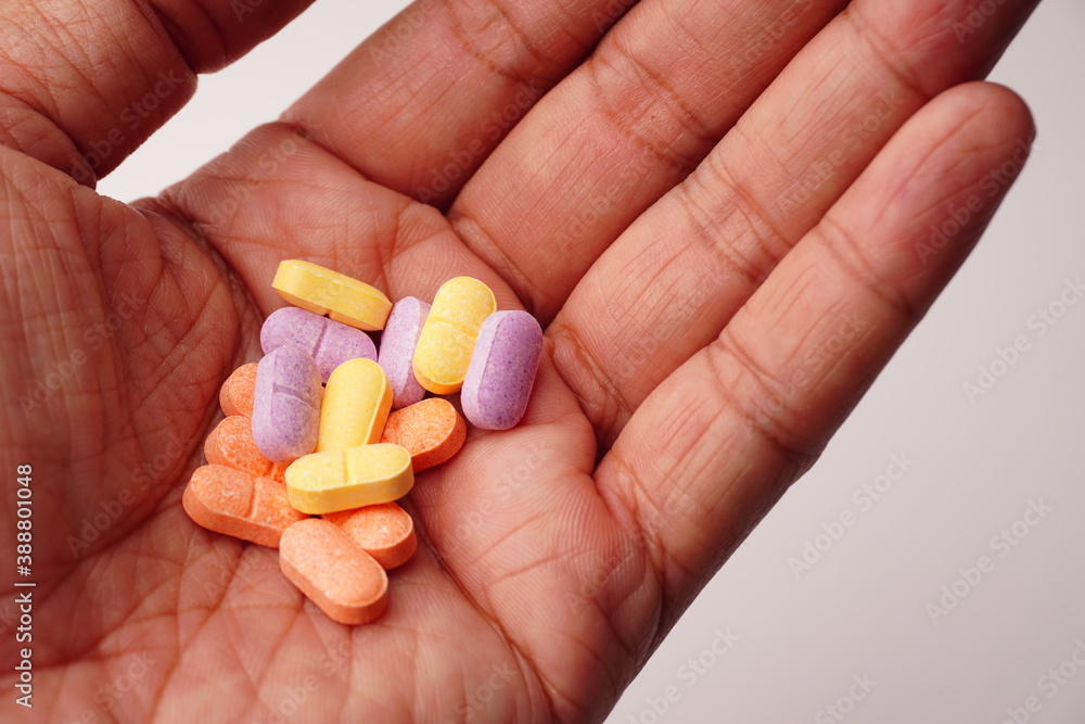 Hand holding pills on white background. Hand holding pills on white background.