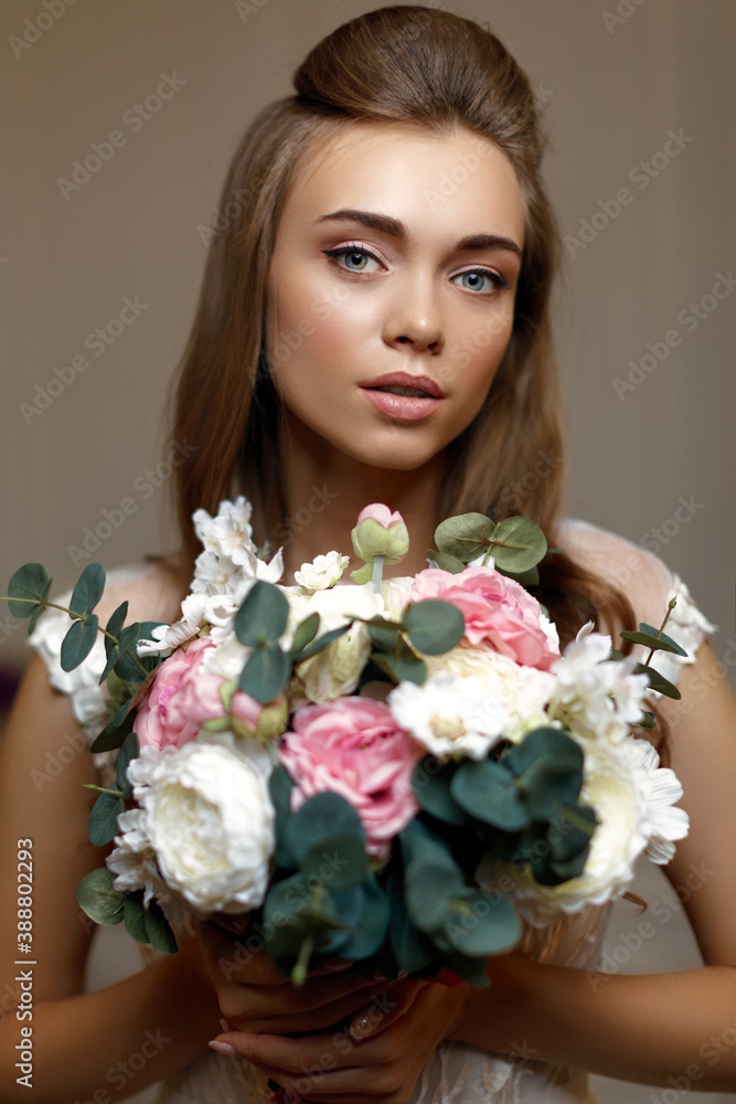 portrait of gorgeous beautiful bride with wedding makeup holding flower bouquet. close-up portrait of gorgeous beautiful bride with wedding makeup holding flower bouquet. close-up