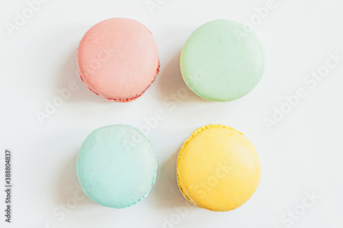 Sweet almond colorful pastel pink blue yellow green macaron or macaroon dessert cake isolated on white background. French sweet cookie. Minimal food bakery concept. Flat lay top view copy space