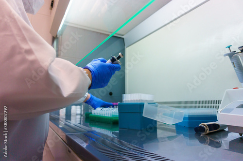 laboratory specialized in analysis of coronavirus, antibodies, covid vaccine, technician in analysis, machinery for covid-19, test tubes, surgical mask, work, autoclave machine, centrifugal machine