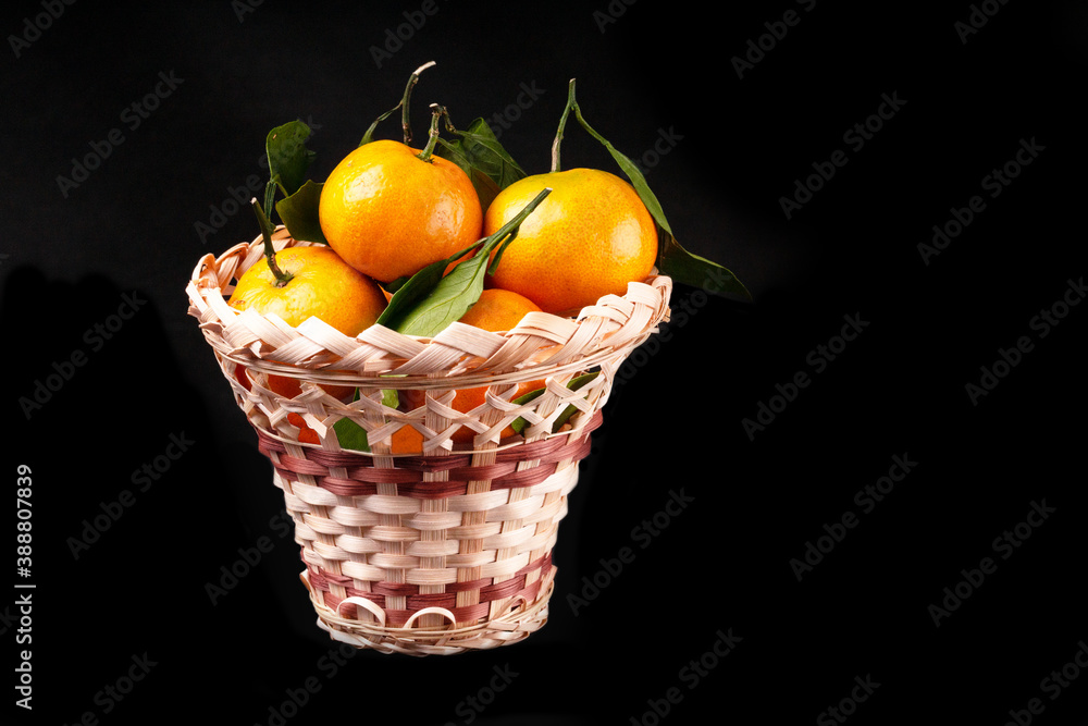 Citrus Ripe orange tangerine with green leaves isolated on a black background organic food full basket Citrus Ripe orange tangerine with green leaves isolated on a black background organic food full basket