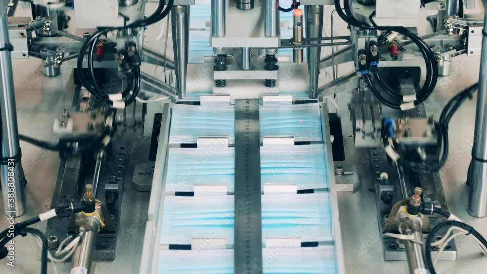 Face masks moving along a conveyor belt Face masks moving along a conveyor belt