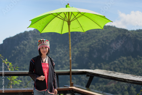 Asian female tourists in Akha tribal costume at Ban Phahee Viewpoint with mountain views, Mae Sai, Chiang Rai Province, Thailand photo