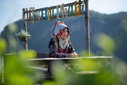 Asian female tourists in Akha tribal costume at Ban Phahee Viewpoint with mountain views, Mae Sai, Chiang Rai Province, Thailand photo