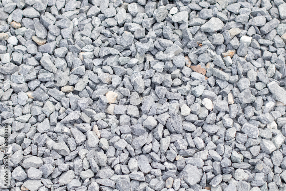Bulk gravel stones background with city street Bulk gravel stones background with city street