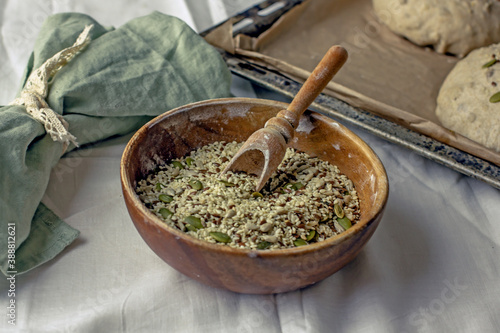 Valokuva Cereal mixture of sesame seeds, pumpkin seeds, sunflower seeds in a wooden bowl with a scoop
