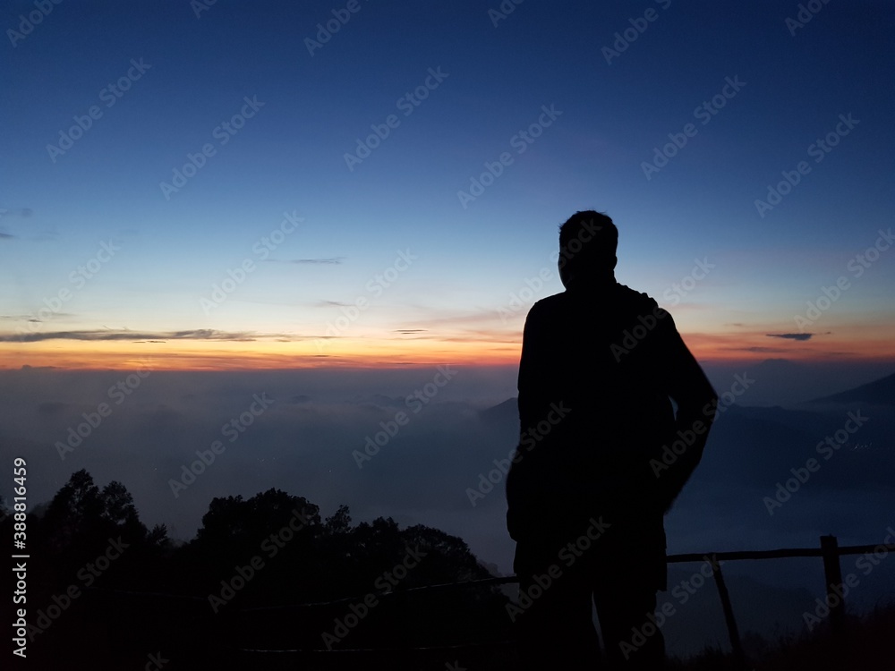 silhouette person at mountain sunrise 