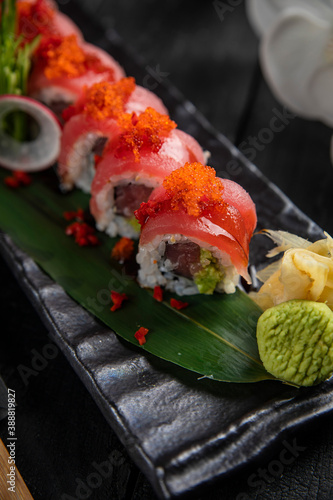Japanese traditional rolls with tuna, caviar, on a dark table 