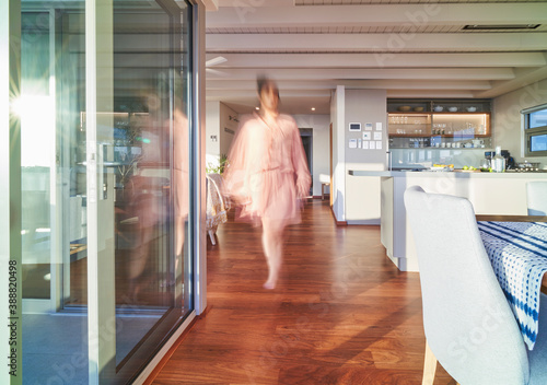 Blurred woman walking in luxury home showcase interior photo