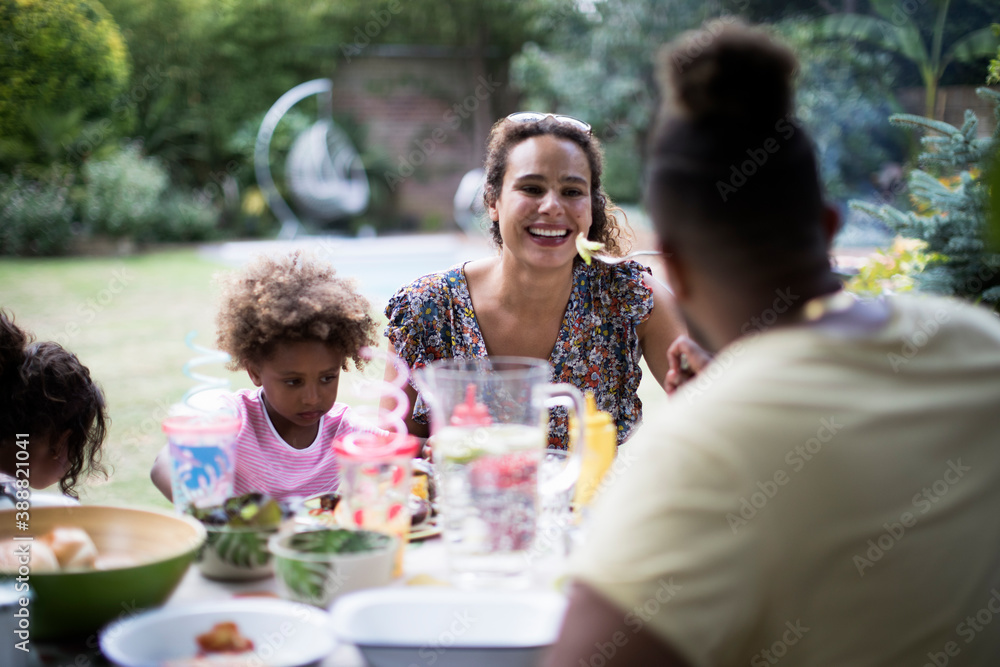 Happy family enjoying lunch on summer patio Happy family enjoying lunch on summer patio