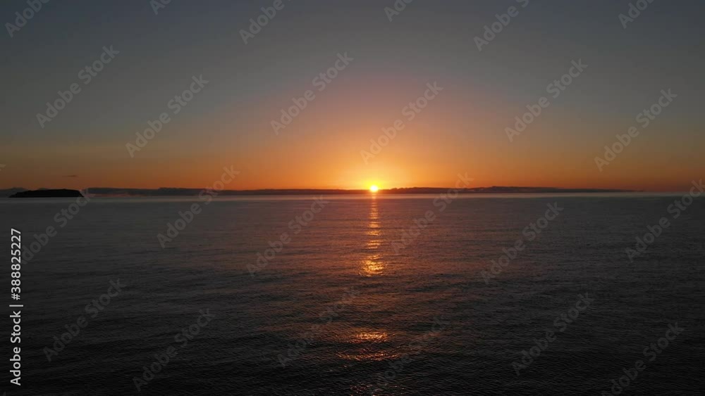 Sunrise over tranquil sea at Matadouro beach in Portugal. Aerial backward Sunrise over tranquil sea at Matadouro beach in Portugal. Aerial backward