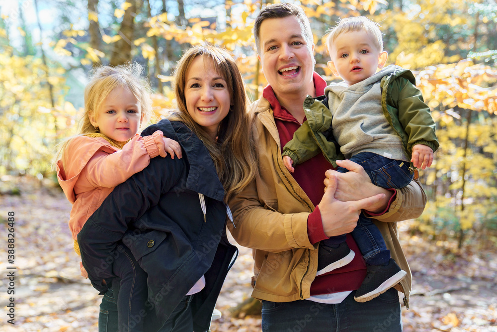 Fototapeta premium family having fun in the autumn forest