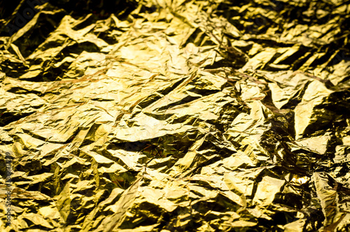 Gold background. Crumpled foil. paper is Golden in color.