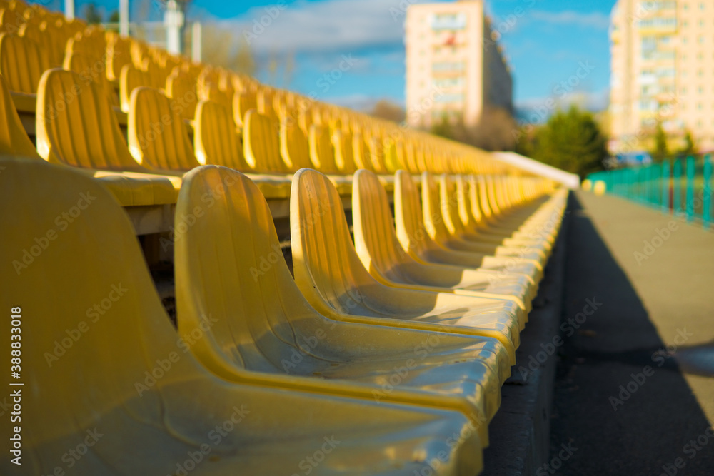 Fototapeta premium Empty sits on a tribune on a stadium due to virus.