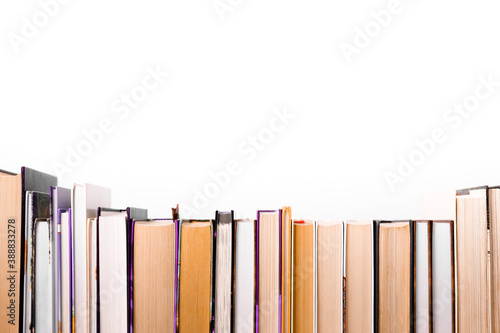 various old books on a shelf on dark background, banner