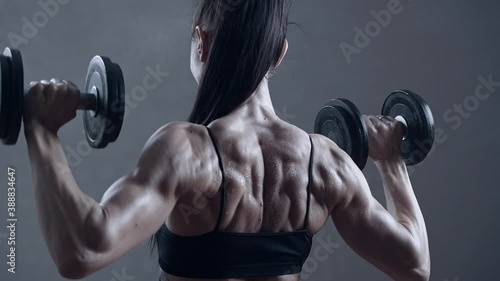 Professional female bodybuilder training muscles