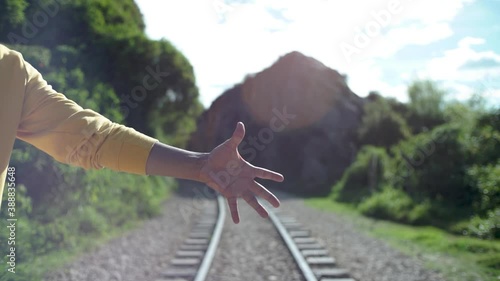 young man's hand holds wooden box he holds it and then drops it