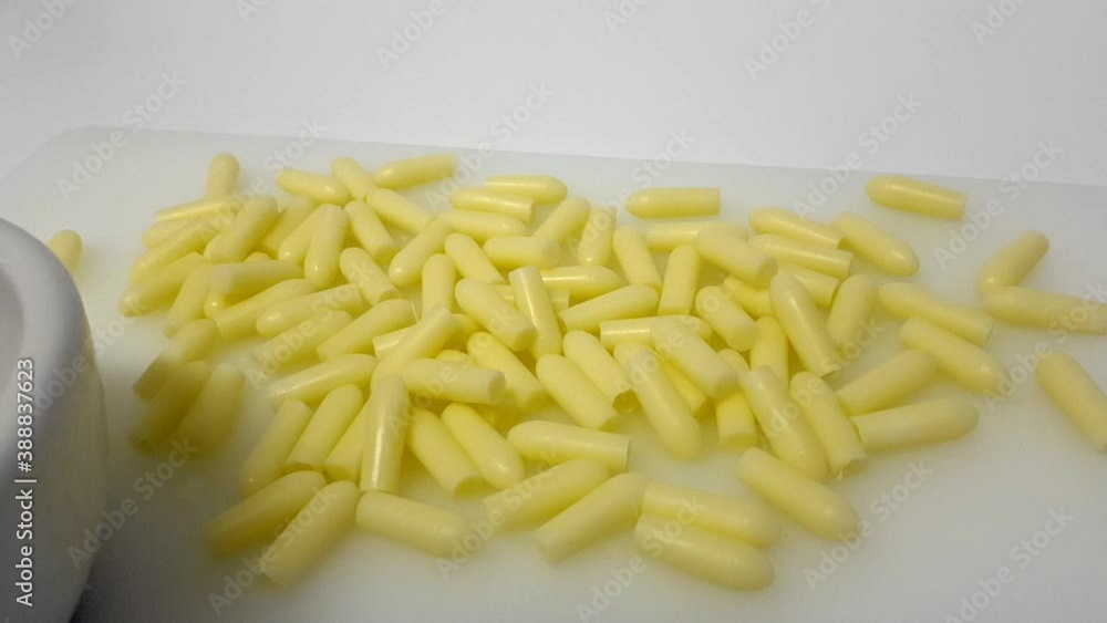 Many yellow glycerin suppositories at lab table for infants and toddlers. Dolly in Many yellow glycerin suppositories at lab table for infants and toddlers. Dolly in