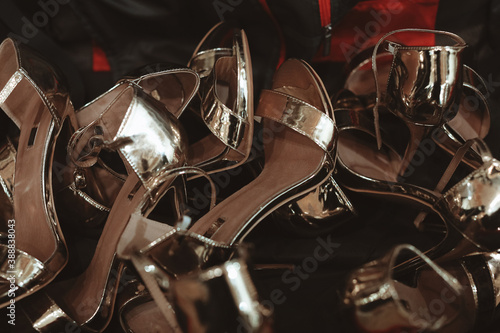 Blurred multitudes of gold high-heeled shoes © asauriet