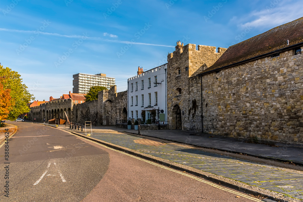 A view along a street with remains of the thirteenth-century town walls in Southampton, UK in Autumn