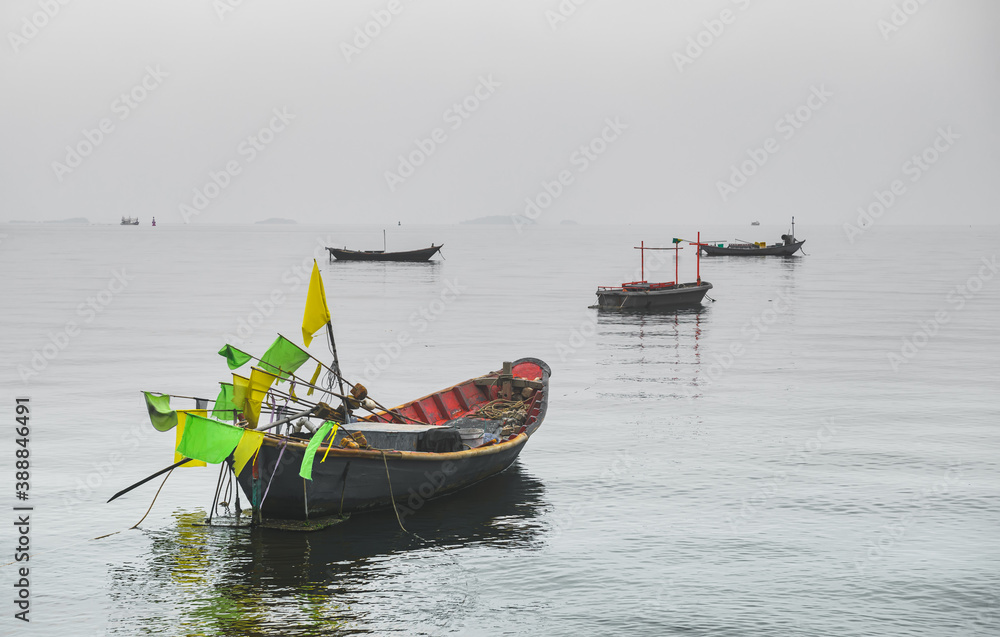 Wooden fishery boats in the sea with fog .Weather.
