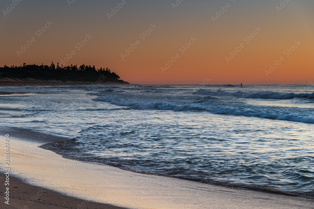 Clear skies and small waves, dawn at the beach