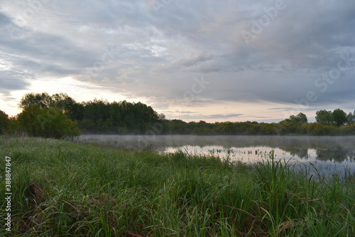 Tableau sur toile colorful and misty dawn over a small river