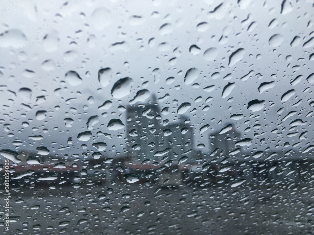Water drops on window glass after rain. Gray wet textured background. Autumn depression and despondency concept. Water drops on window glass after rain. Gray wet textured background. Autumn depression and despondency concept.