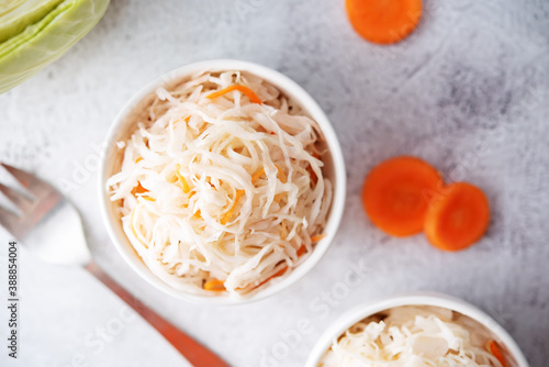 Fresh raw pickled cabbage with casrrot in a white bowl