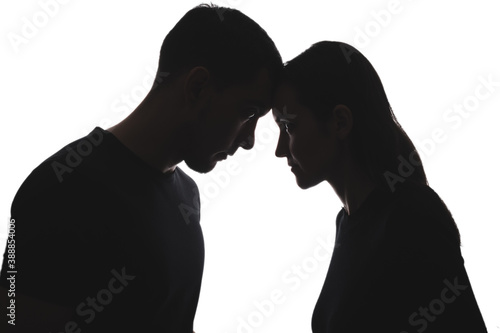 black and white silhouettes of portraits men and women on white background stand opposite each other, touching their foreheads. feminism, masculism photo