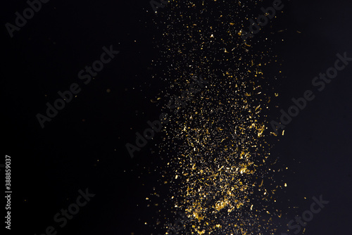 abstract background floating gold glitter on black background