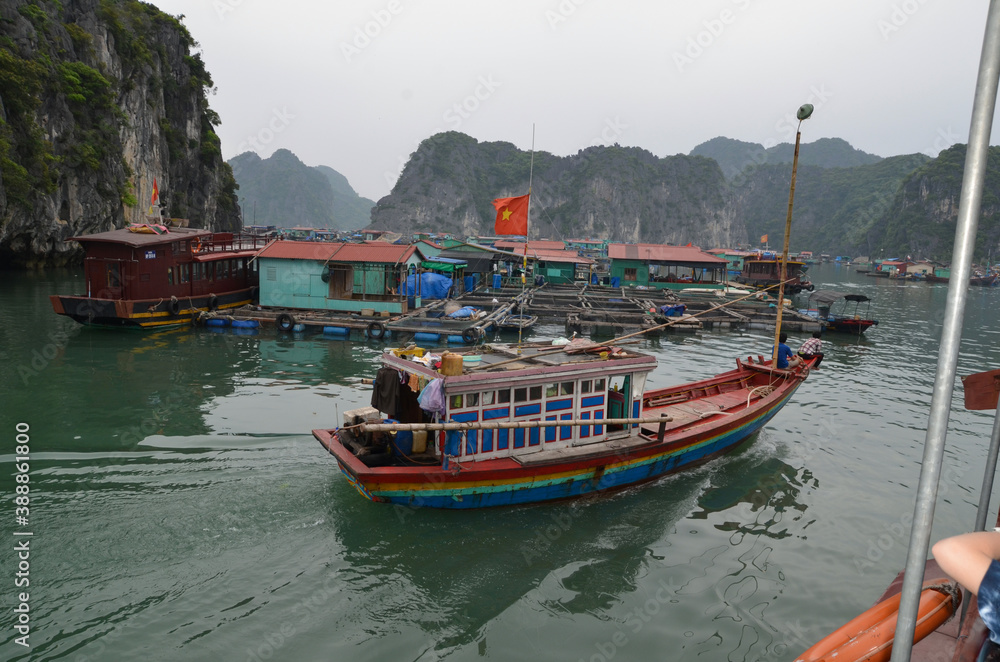 Small boat in the background of the fishing village. Vietnam. Halong. Small boat in the background of the fishing village. Vietnam. Halong.