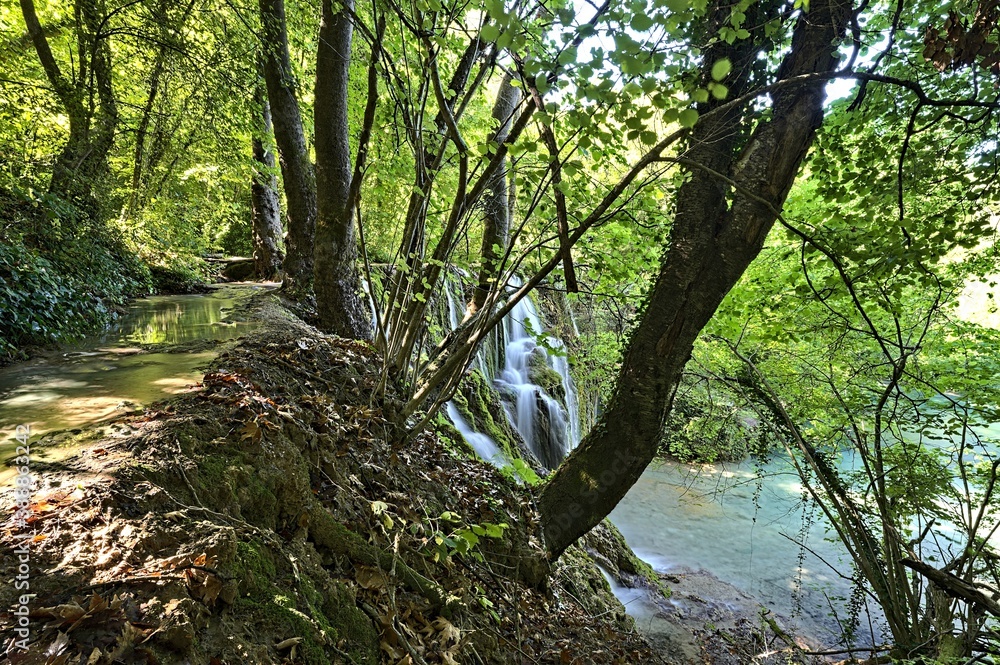 Fototapeta premium Skra Waterfall in Greece shot from the path heading to the swim entry