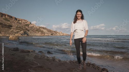 Young caucasian brunette woman doing youga on the sandy beach in the morning. High quality photo photo