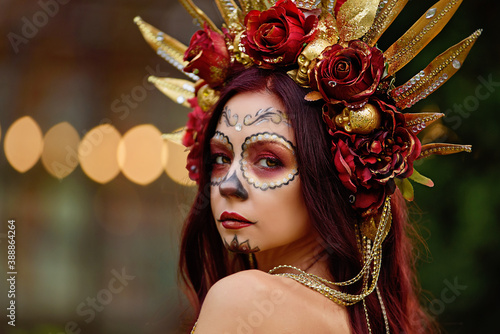 Closeup portrait of Calavera Catrina in red dress. Sugar skull makeup. Dia de los muertos. Day of The Dead. Halloween © Serenkonata