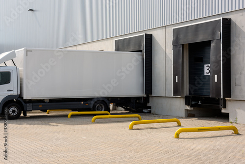 truck at loading ramps of a warehouse photo