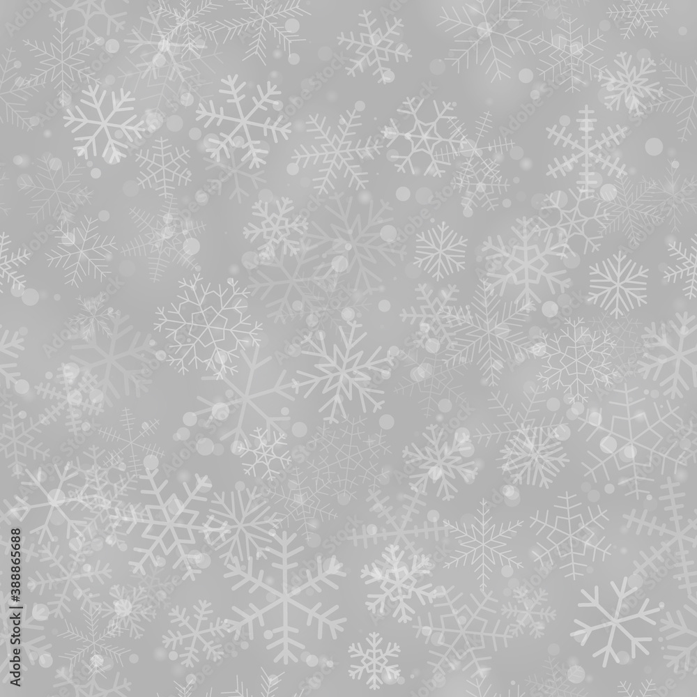 Christmas seamless pattern of snowflakes of different shapes, sizes and transparency, on gray background
