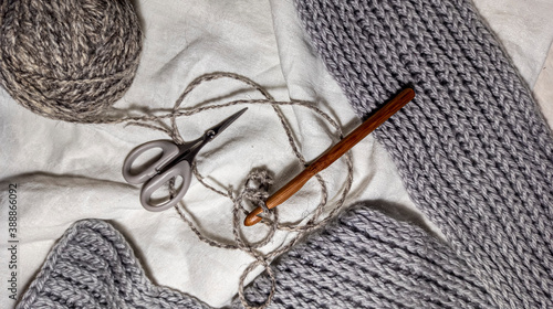 Photo of a crochet hook, wool yarn queens, knitting. Gray color scheme. Background for  content. Crochet. Hobby. Flatley.